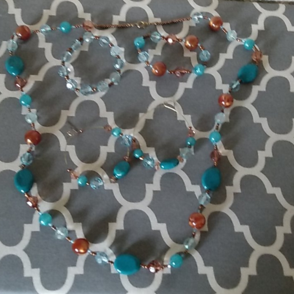 A set with a necklace, bracelet, and earrings